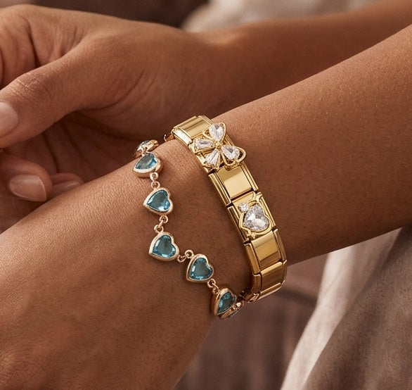 Gold 9mm Italian charm bracelet with heart-shaped blue stones on a wrist
