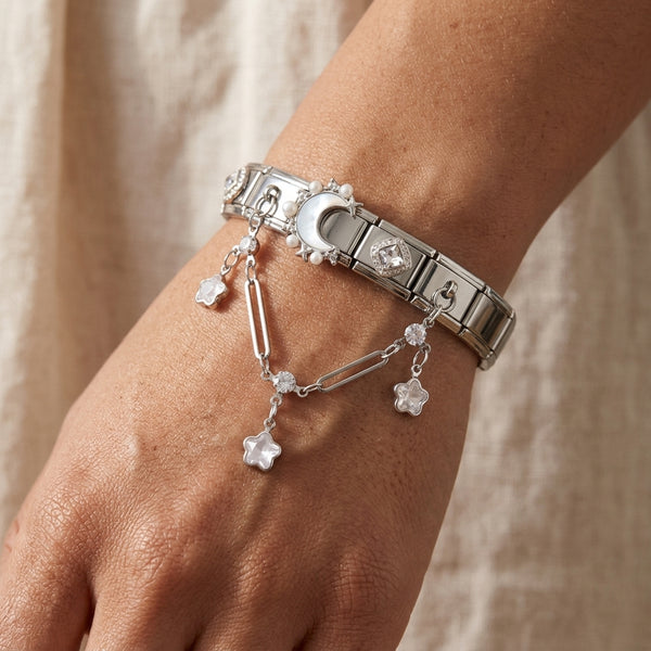 Silver 9mm Italian charm bracelet with paperclip accent chain with star charms on a wrist against a neutral background