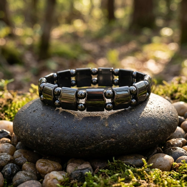 Mens Black Hematite Magnetic Beaded Bracelet Displayed On A Rock