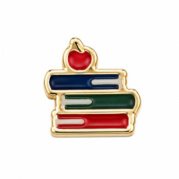 A gold-tone Floating charm shaped like a stack of books with an apple on top, featuring blue, green, and red enamel fills on a white background.