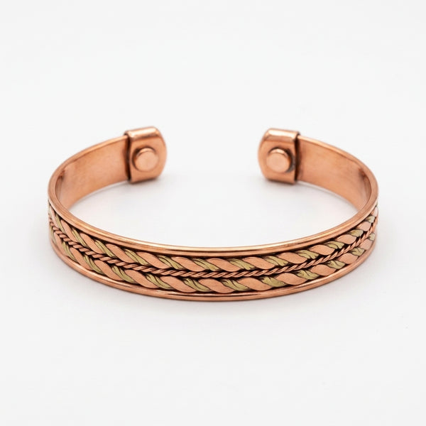 Copper bracelet with two tone braided design on a white background