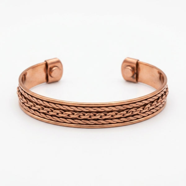 Copper cuff bracelet with braided design and magnets on a white background