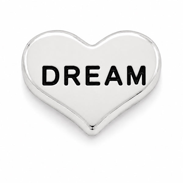 A polished silver heart-shaped Floating charm with the word 'DREAM' embossed in black capital letters across the center, shown on a clean white background.