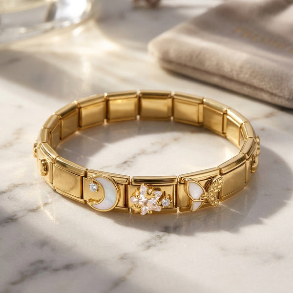 Gold 9mm Italian charm bracelet with decorative crystal and white elements on a marble surface