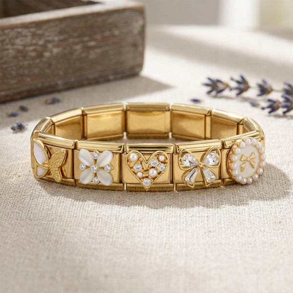 Gold Italian charm bracelet various crystal and pearl charms on a textured surface