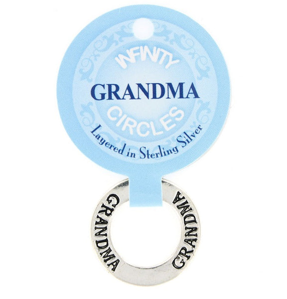 A silver silver plated infinity circle token chip labeled 'GRANDMA' with a light blue paper hanger tag that reads 'INFINTY GRANDMA CIRCLES Layered in Sterling Silver'.