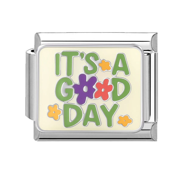 A 9mm Italian charm featuring a retro-style enamel design with the text 'IT'S A GOOD DAY' in green, purple, and pink lettering with small flower accents on a cream background.