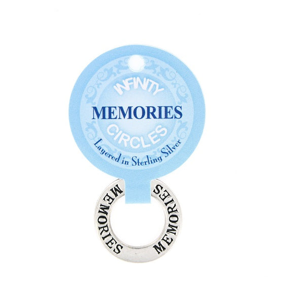 A silver plated infinity circle charm with 'MEMORIES' engraved, attached to a light blue circular display card labeled 'INFNTY CIRCLES Layered in Sterling Silver'.