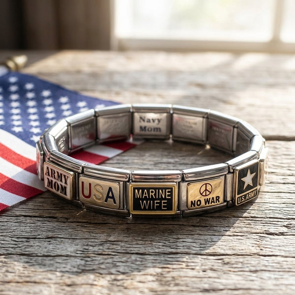Silver italian charm bracelet with various patriotic links on a wooden surface with an American flag in the background