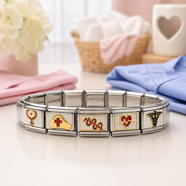 A stainless steel 9mm Itlalian charm bracelet with five nurse themed links, displayed on a light surface with soft pink and blue fabric props in the background.