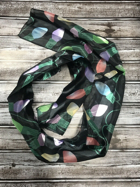 Sheer Black Christmas scarf with multicolor light bulbs showing length and drape
